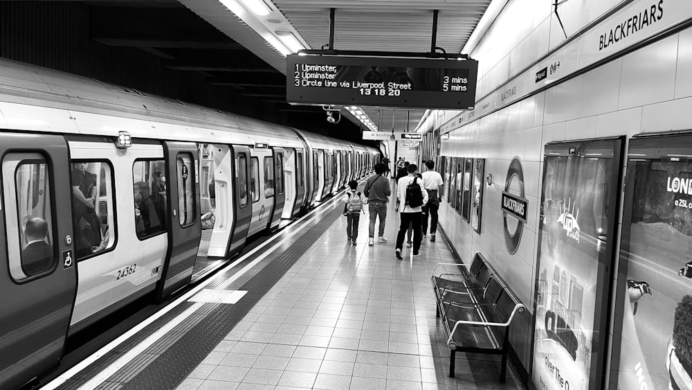 a black and white photo of a subway station