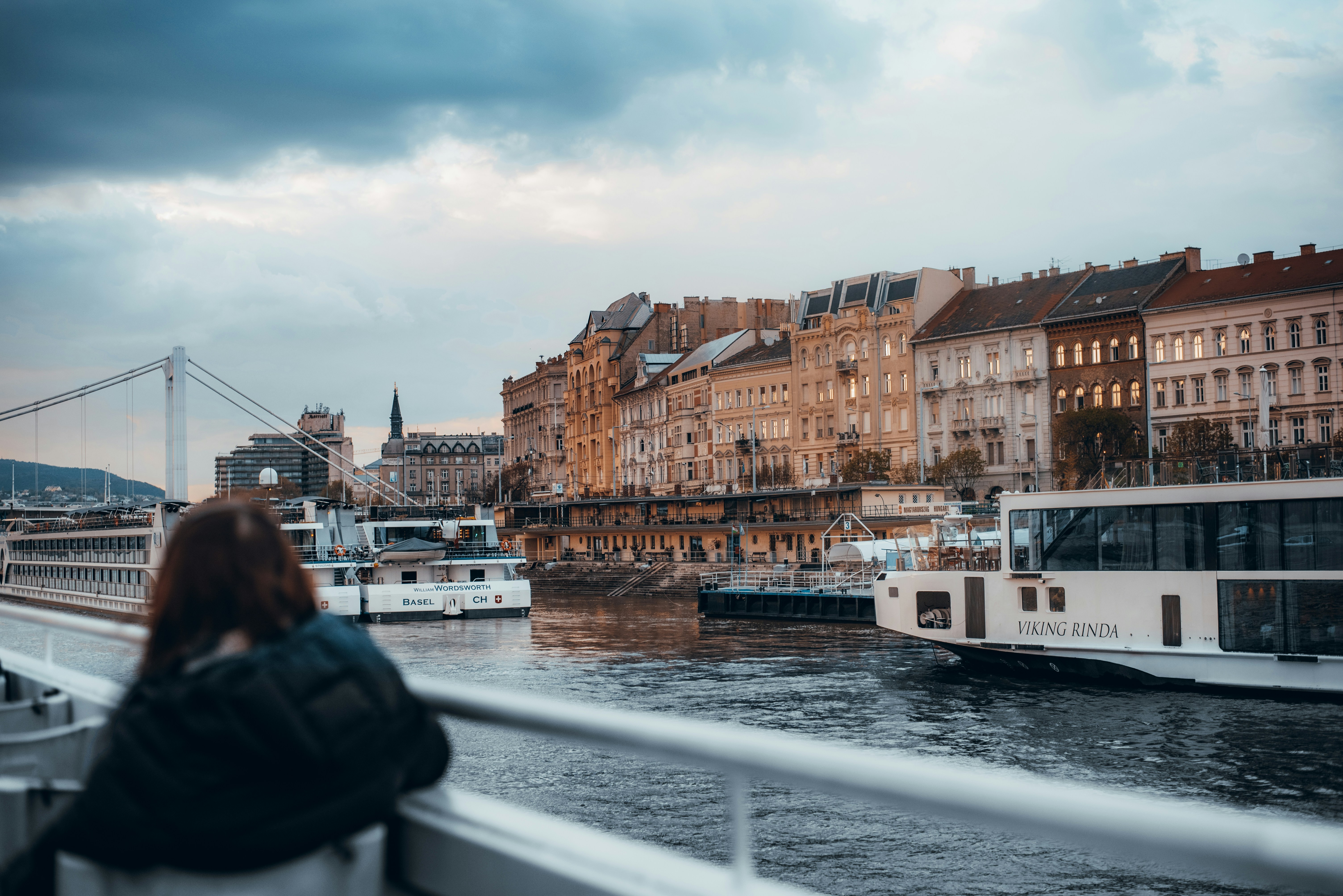 a woman is looking out over the water