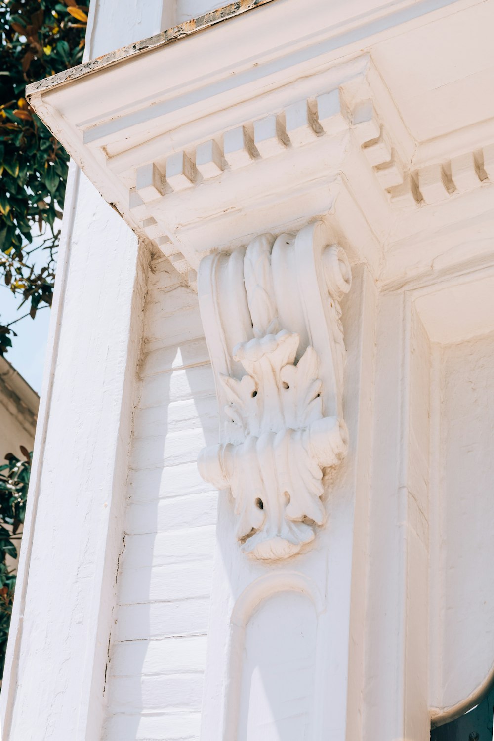 a white building with a clock on the side of it