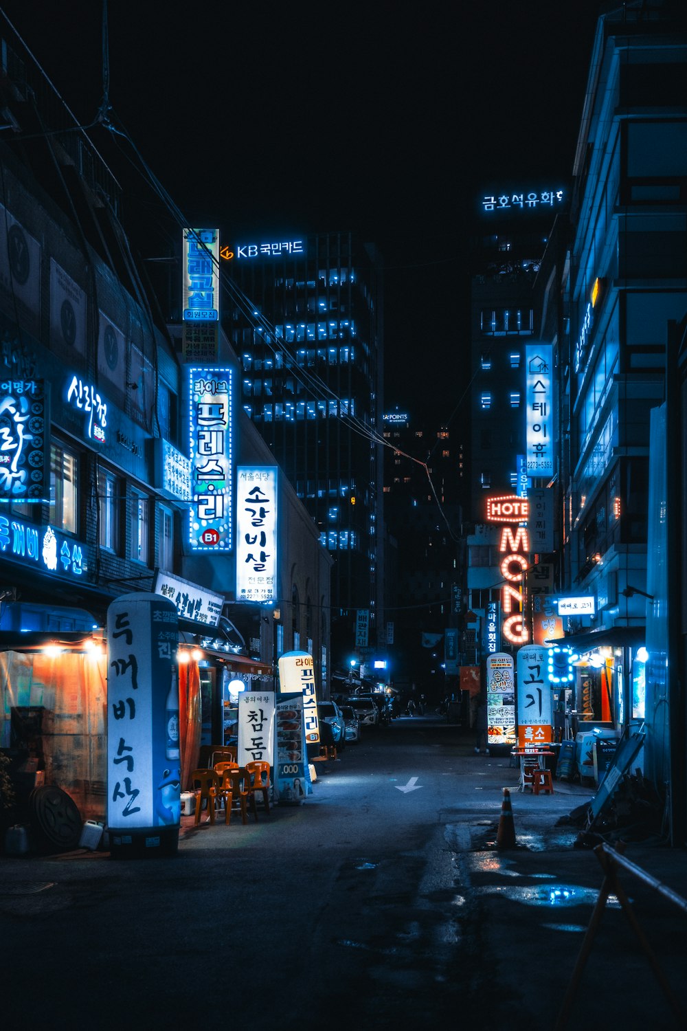 a city street at night with neon signs