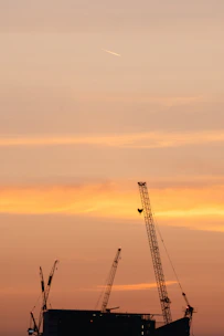 Aerial view of a large-scale civil infrastructure project under construction at sunset.