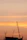 A construction site with cranes and workers, captured from a drone’s aerial perspective at sunset.