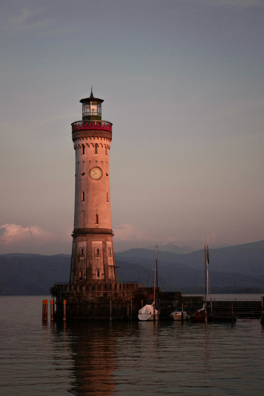 a light house sitting on top of a body of water