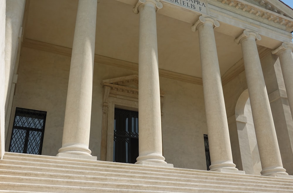 a building with columns and a clock on the front of it