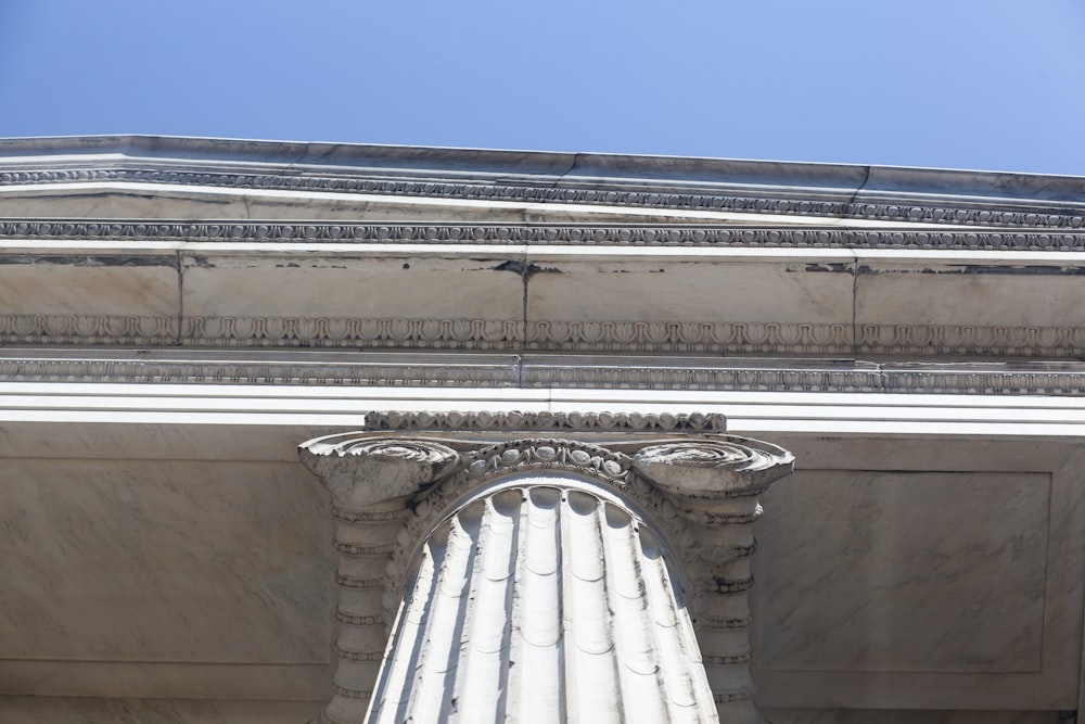 a tall white column with a sky background