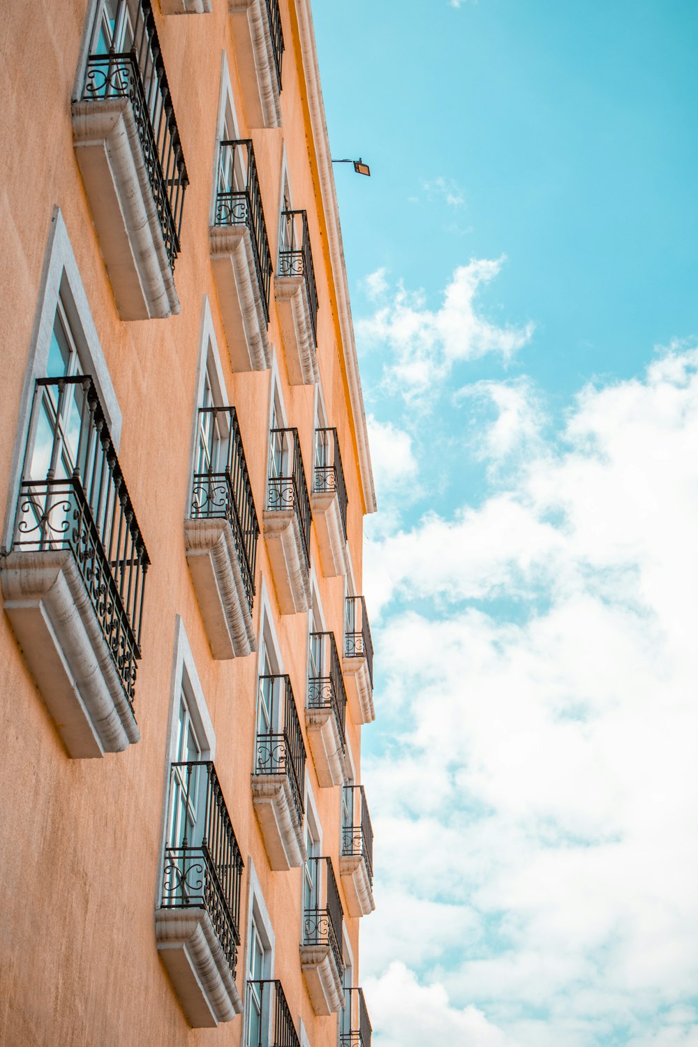 a tall orange building with balconies and balconies