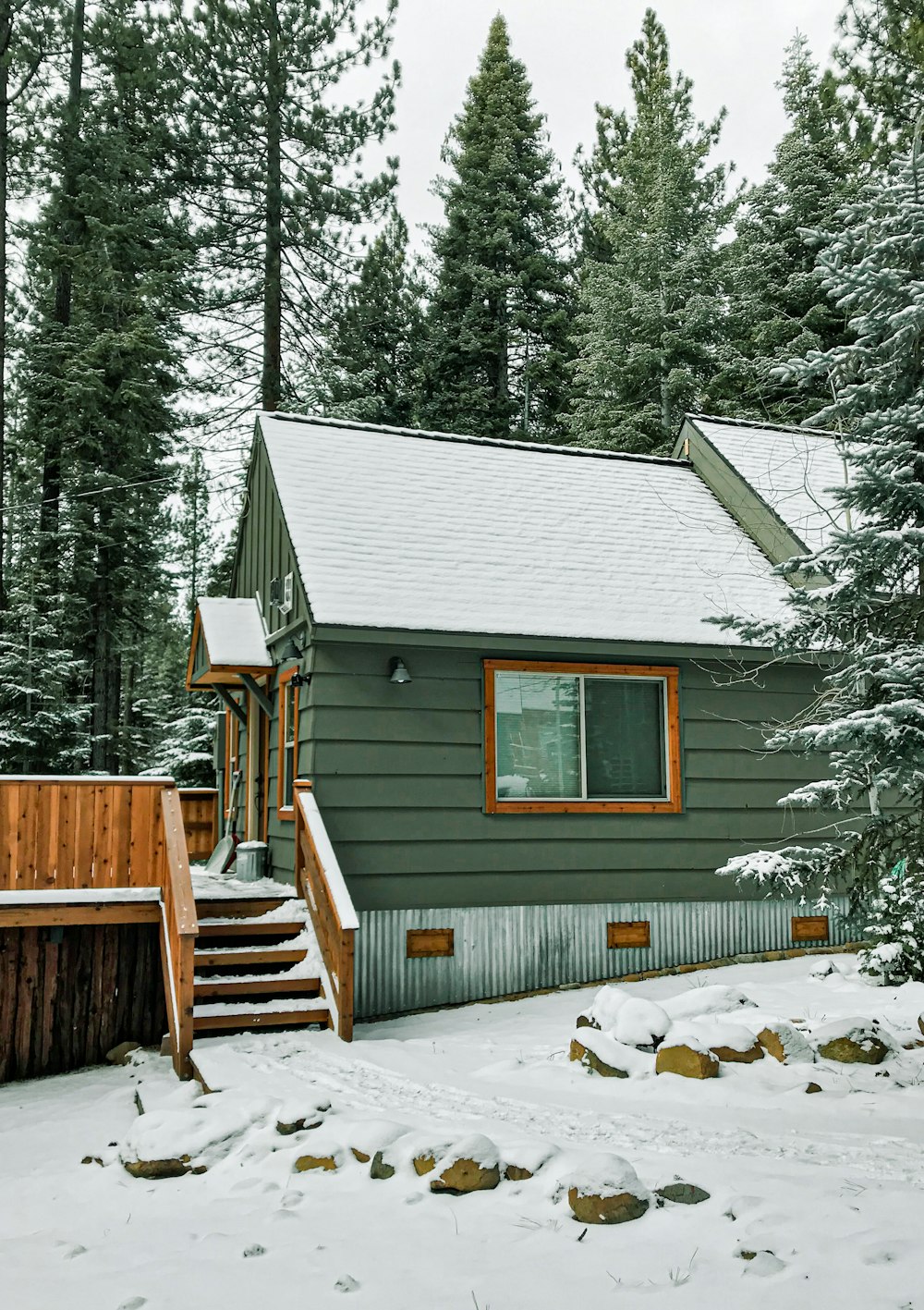 a cabin in the woods with snow on the ground