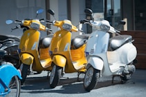 a row of mopeds parked next to each other