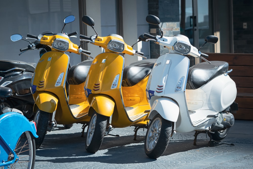 a row of mopeds parked next to each other