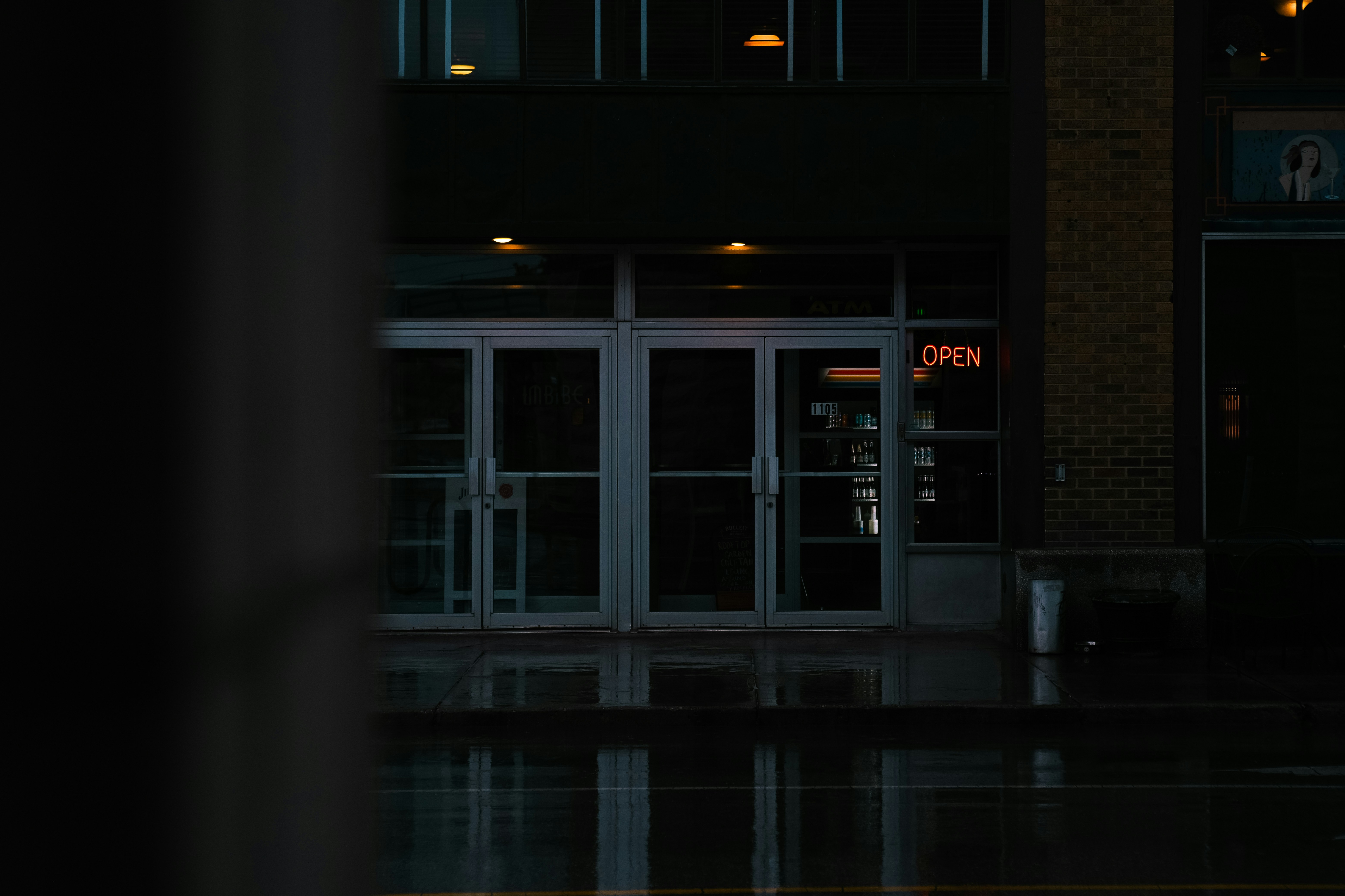 a person walking down a street at night