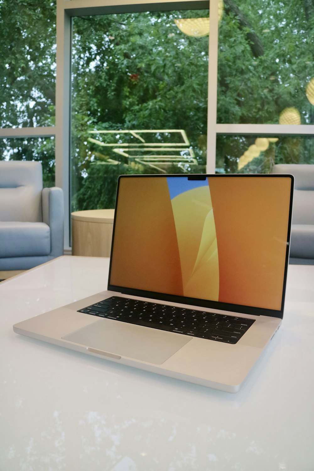 a laptop computer sitting on top of a white table