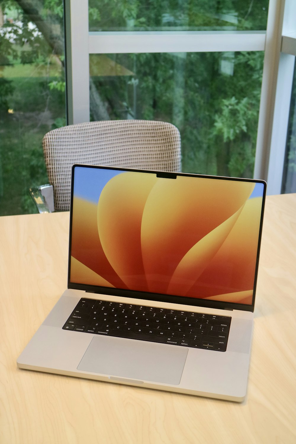 a laptop computer sitting on top of a wooden table