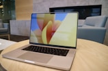 A sleek laptop displaying a colorful marketing campaign layout.