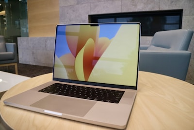 A sleek laptop displaying a colorful marketing campaign layout.