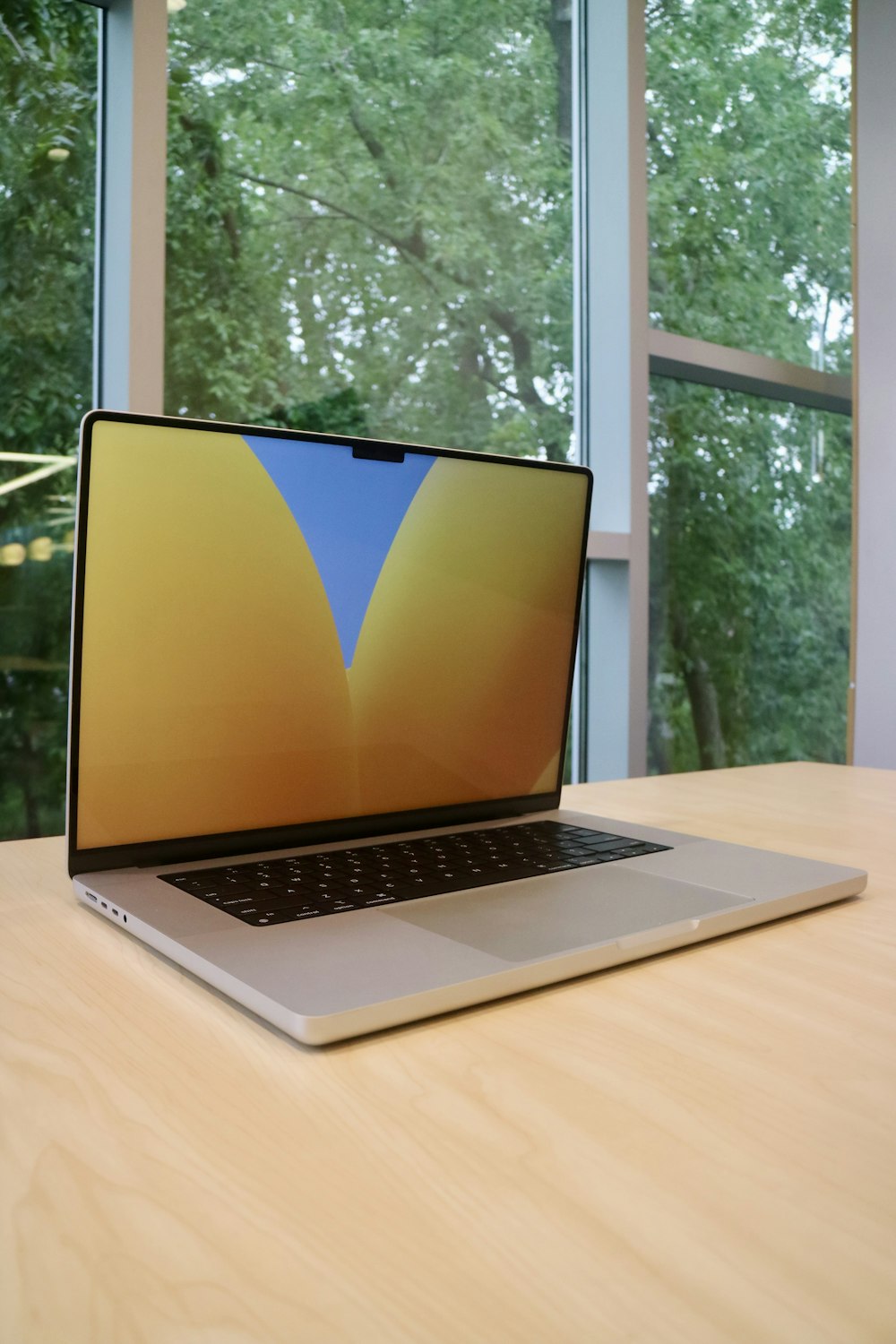 a laptop computer sitting on top of a wooden table