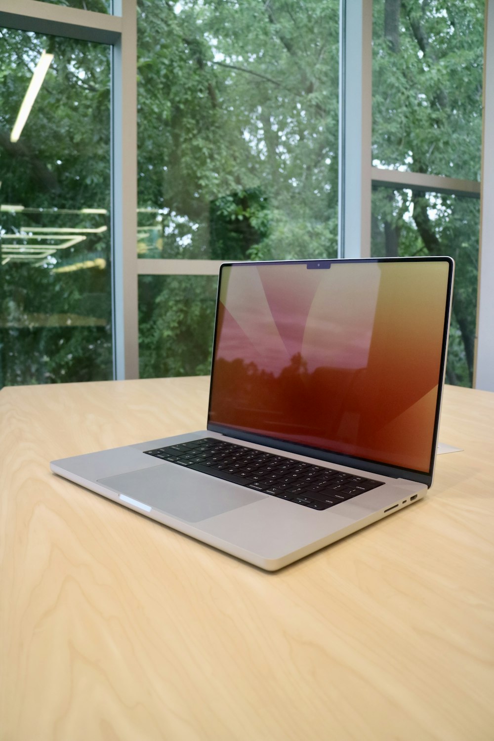 a laptop computer sitting on top of a wooden table