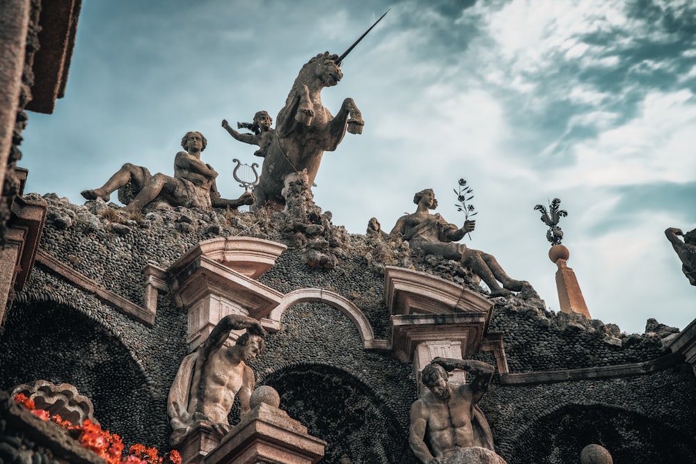 a statue of a man riding a horse on top of a building