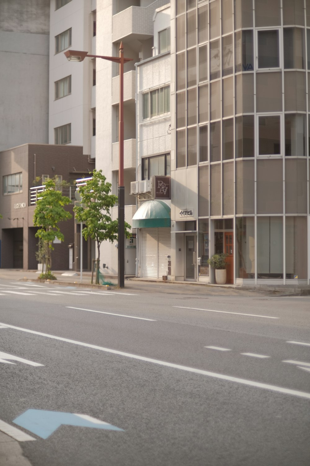 a city street with buildings and a street light