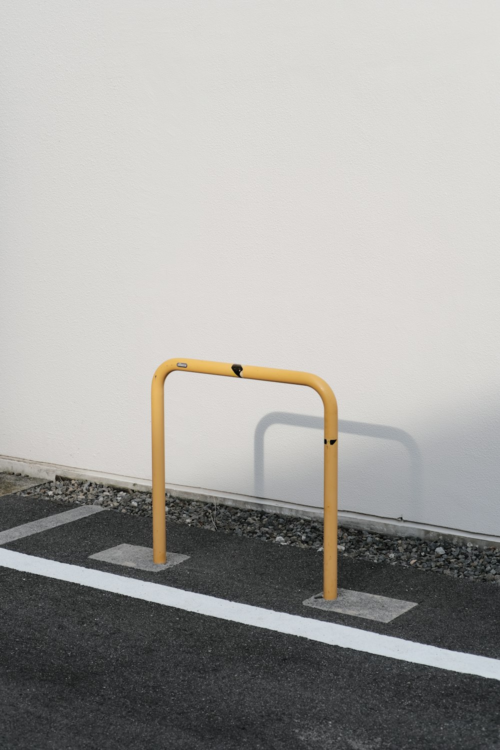 an empty parking space with a yellow gate