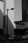 Monochrome photograph capturing shadows and light on urban architecture