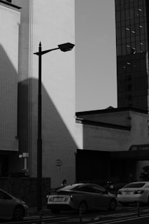 Monochrome photograph of an urban scene with dramatic lighting and contrast.