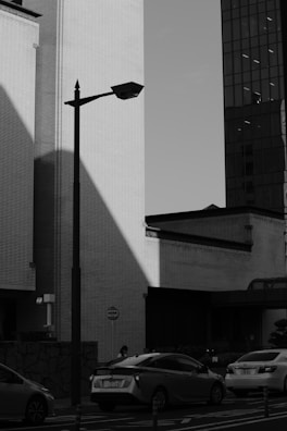 Urban street scene in monochrome with strong contrasts and dynamic composition.