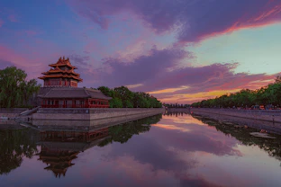 An elegant shot of a traditional Chinese ancient building with intricate details at sunset.