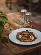 A rustic dish inspired by the flavors of the local territory served on a wooden table.
