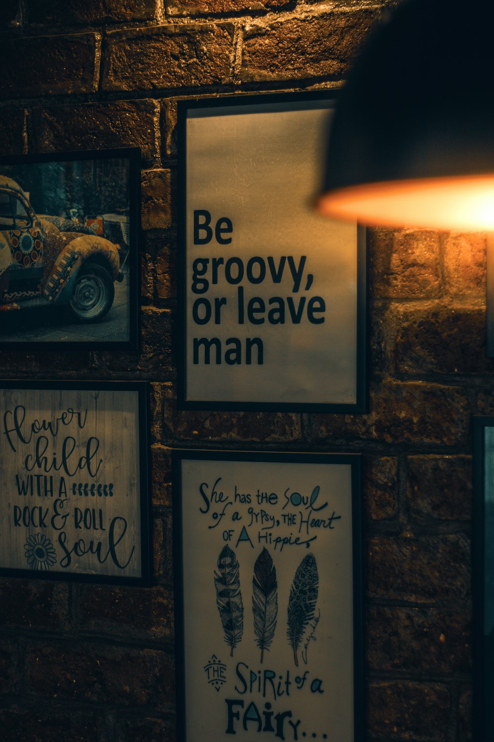 a brick wall with posters on it and a lamp