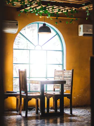 Finished custom dining table set in a warm, natural light-filled room.