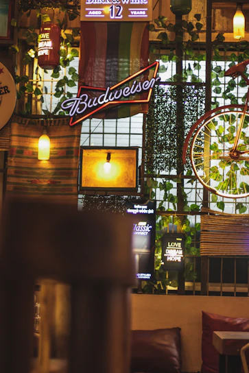Cozy hostel lobby with warm lighting and a vibrant bistro bar in the background.