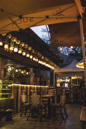 A charming café terrace with warm lighting inviting travelers to relax.