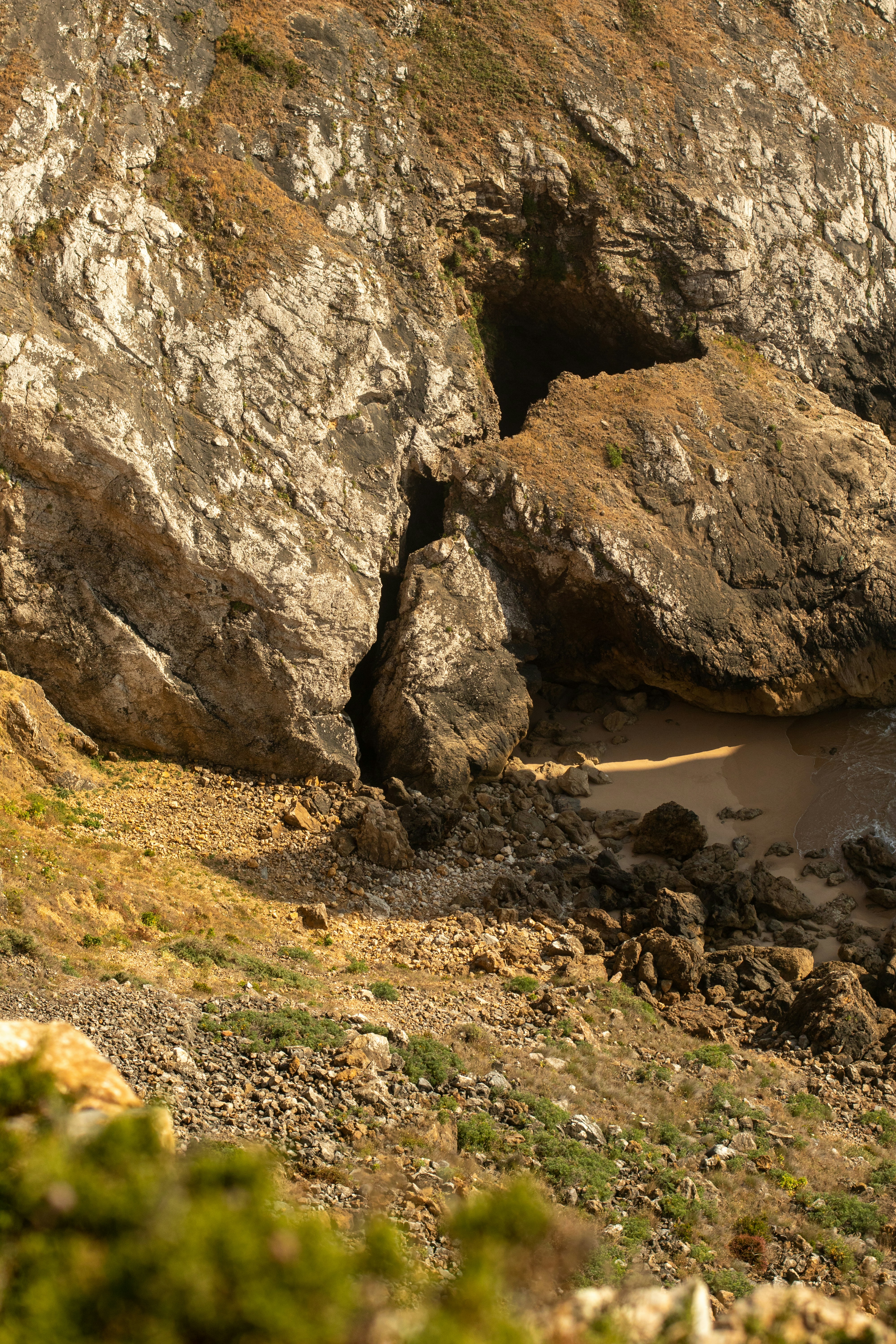 a large rock formation with a body of water in the middle of it