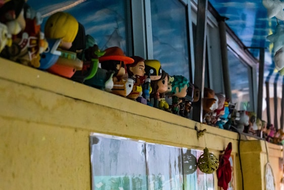A cozy display shelf filled with vibrant collectible figures under warm lighting.