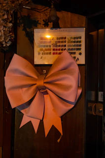 A set of cute 3D printed bow holders in soft pink and white, arranged neatly on a vanity