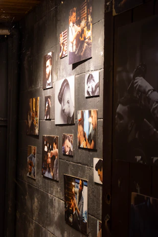 Display of various haircut styles on a rustic wooden wall inside the barbershop.