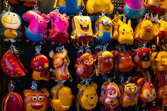 Close-up of colorful custom acrylic and PVC keychains hanging on display.