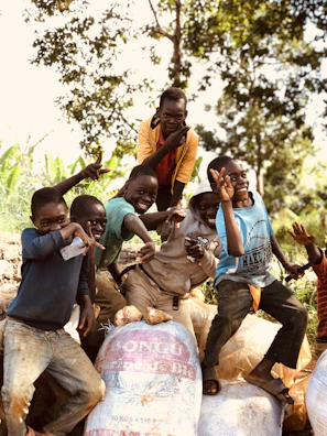Group of happy kids showing off their matching t-shirts and bags.