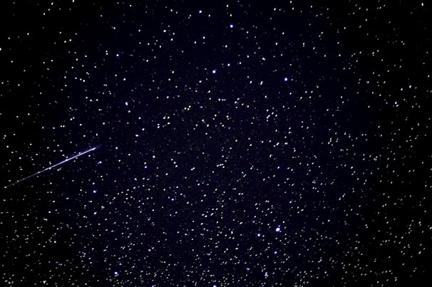 A vibrant cosmic illustration showing the sun, moon, stars, and shooting stars interconnected, symbolizing leadership styles.