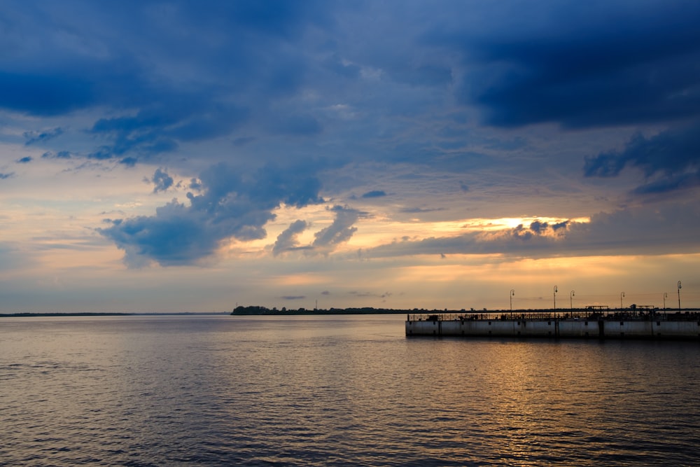 a large body of water under a cloudy sky