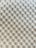 A textured surface with a repetitive pattern of raised circular bumps, resembling a bubble wrap or embossed material. The lighting casts subtle shadows, highlighting the three-dimensional quality of the texture.