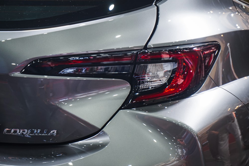 a close up of the tail light of a silver car