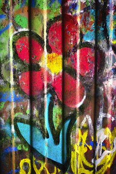 Close-up of Banksy's 'Flower Thrower' stencil art on a concrete surface.