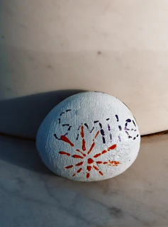 a painted rock sitting on top of a white counter