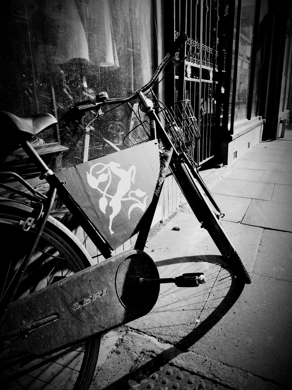 a bicycle parked on the side of a street