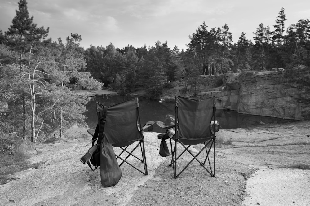 a couple of chairs sitting on top of a cliff