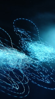A series of swirling, luminescent blue lines and patterns on a dark background, creating an abstract and dynamic visual effect.
