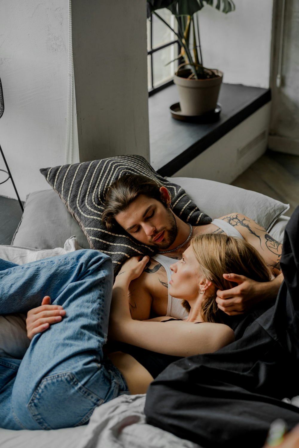 a man and a woman laying on a bed