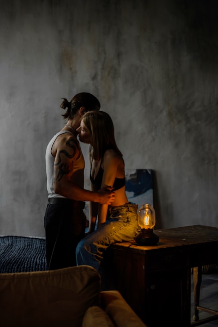 Sensual scene featuring two stars in a dimly lit room