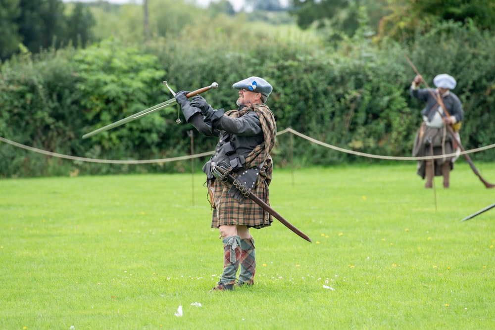 a group of men in kilts playing a game